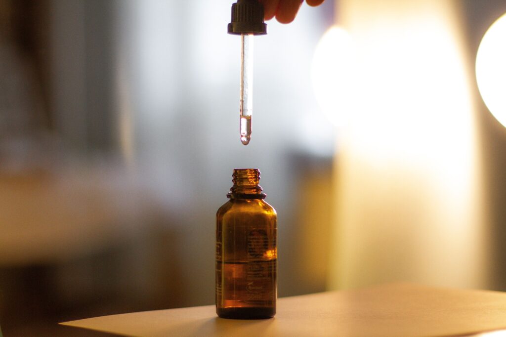 Dropping liquid from amber bottle