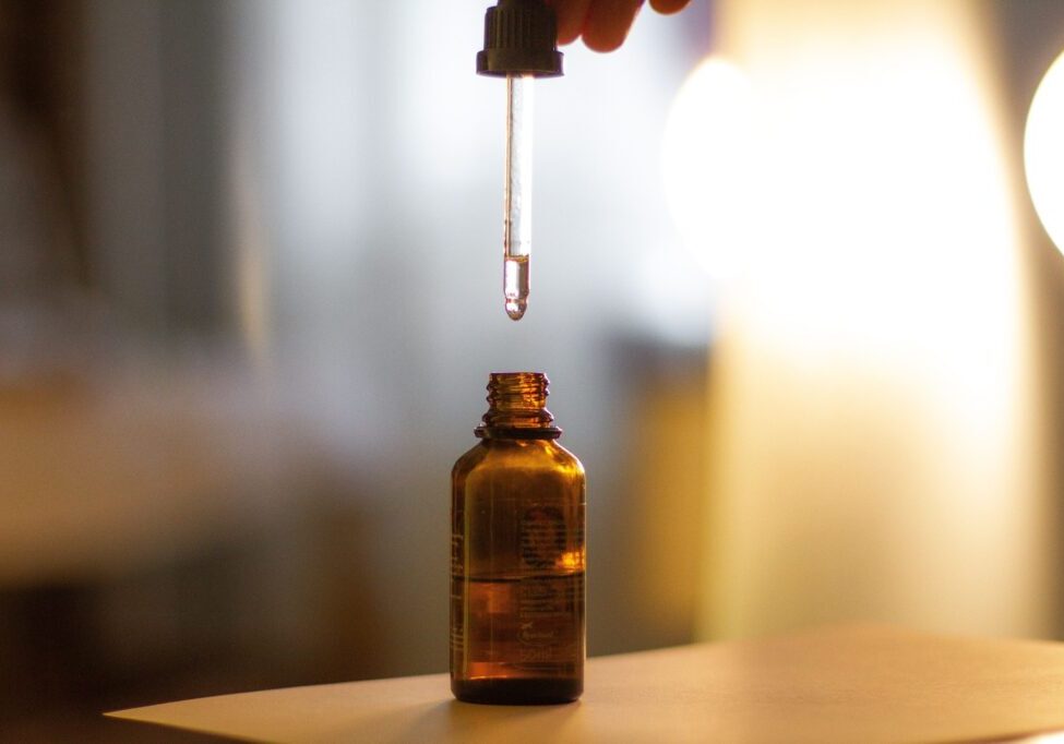 Dropping liquid from amber bottle